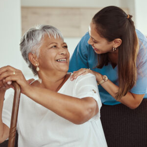 caregiver helping older woman in her home