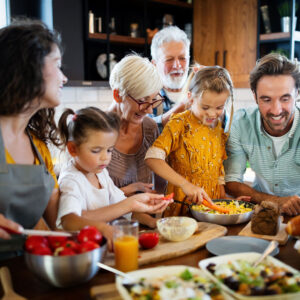 a family with multiple generations cooking food together
